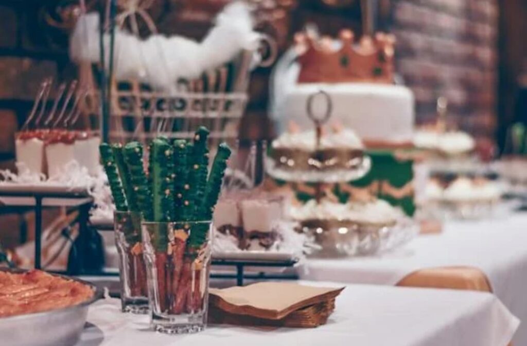A dessert table with sweets and a book, possibly at a party or event