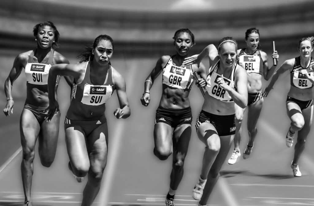 A black and white photo of female athletes running a race