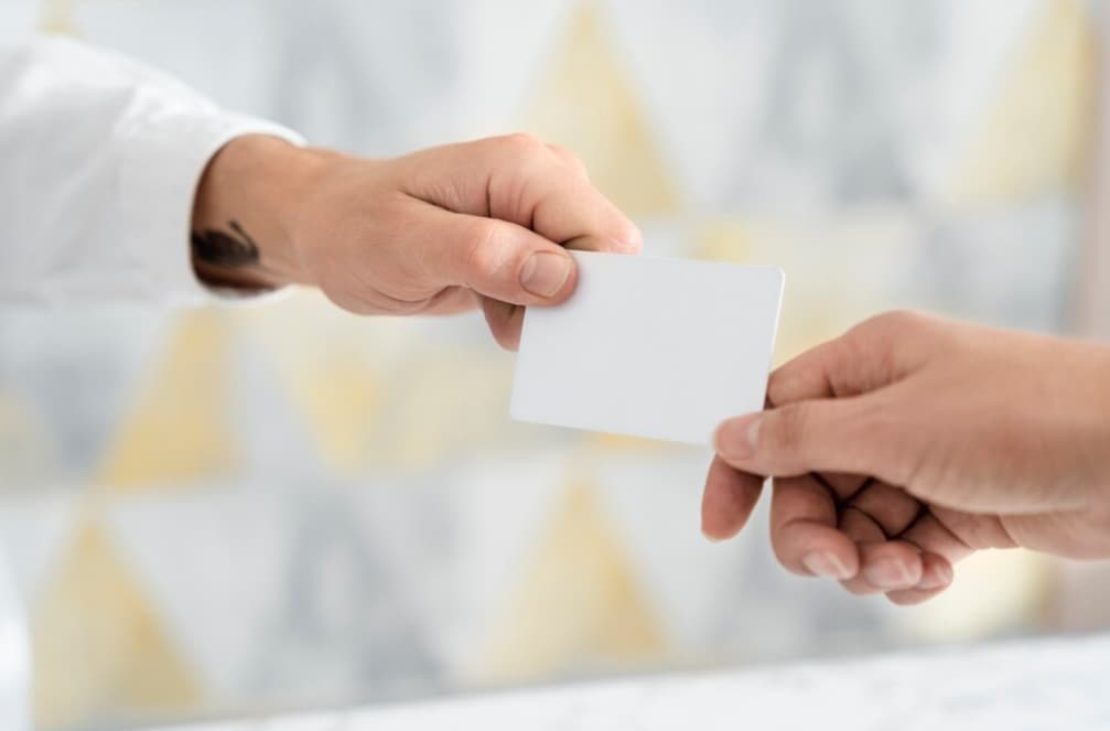 hand passing the empty white card to other person